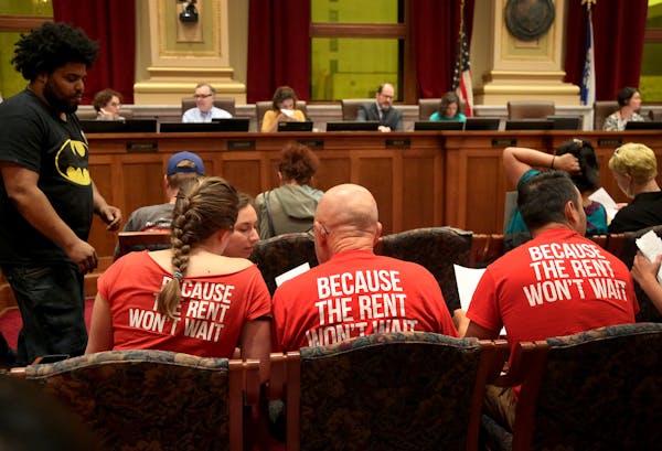 Supporters of a $15 Minneapolis minimum wage confer as the Minneapolis City Council Committee of the Whole Municipal minimum wage ordinance the counci