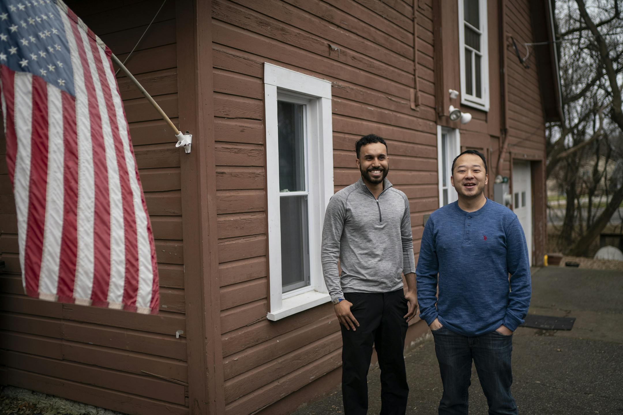 Mohamed Malim, 23, founded a company called Epimonia that makes bracelets and hats out of repurposed life jackets the refugees have likely used during boat trips to Greece. He posed for a photo with Peng Cha, who's parents were also refugees from Laos, at Cha's production facility where the product is made in Maplewood, Minn., on Tuesday, November 26, 2019. ] RENEE JONES SCHNEIDER ¥ renee.jones@startribune.com