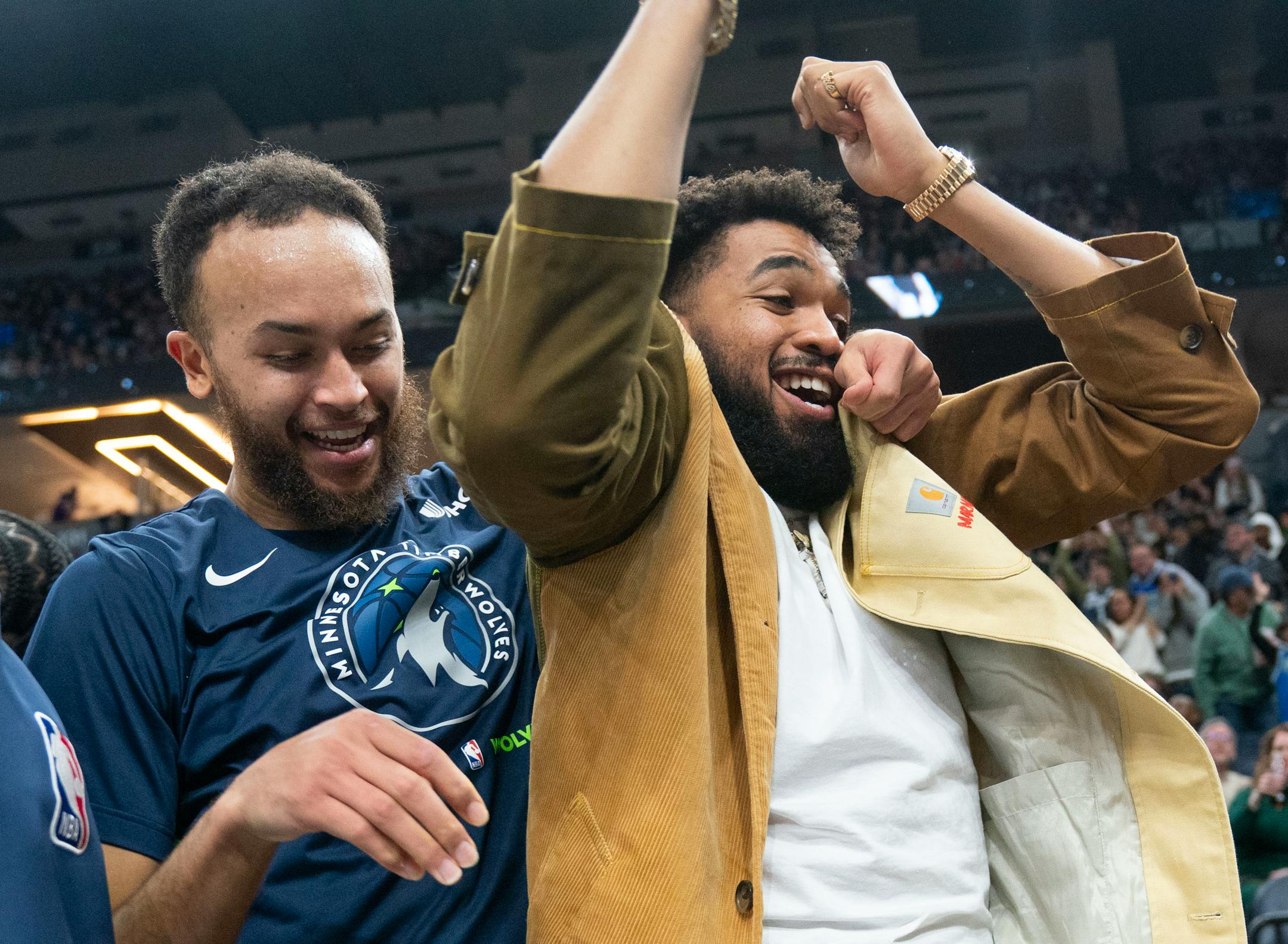 Minnesota Timberwolves forward Kyle Anderson (5) and center Karl-Anthony Towns (32) react to a dunk by Minnesota Timberwolves center Naz Reid (11) against the Cleveland Cavaliers in the third quarter Saturday, Jan. 14, 2023 at Target Center in Minneapolis. ]