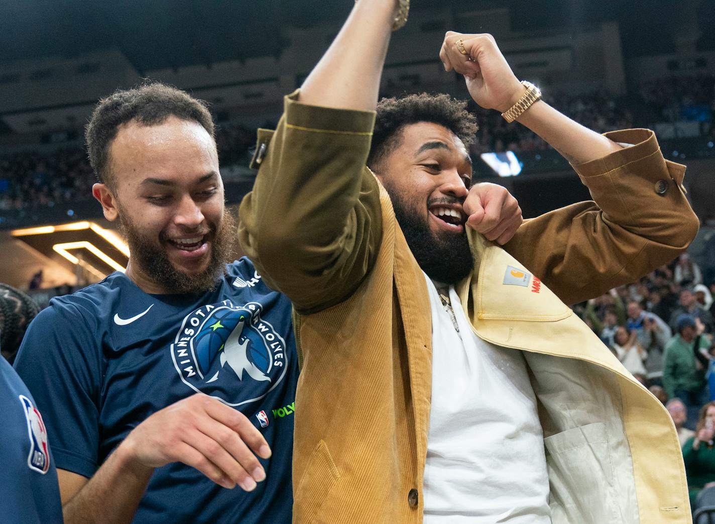 Minnesota Timberwolves forward Kyle Anderson (5) and center Karl-Anthony Towns (32) react to a dunk by Minnesota Timberwolves center Naz Reid (11) against the Cleveland Cavaliers in the third quarter Saturday, Jan. 14, 2023 at Target Center in Minneapolis. ]