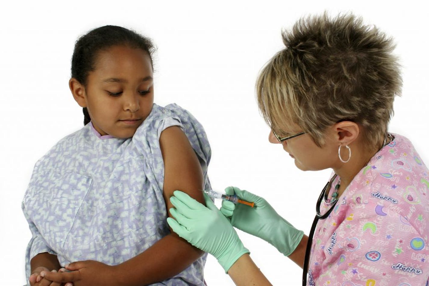 A nurse vaccinates a scared little girl.