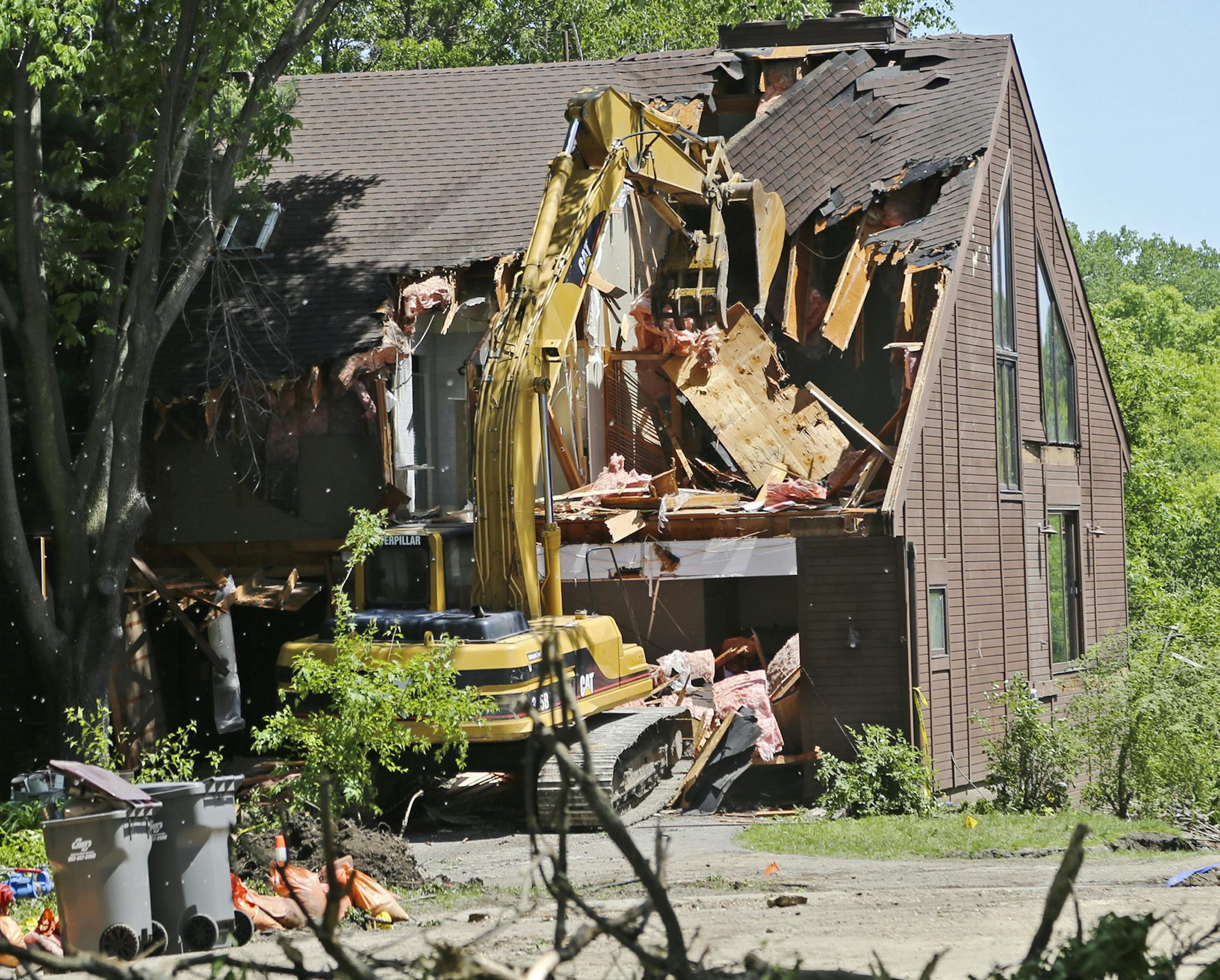 Crews work to demolish a home Tuesday, June, 3, 2014, in Eden Prairie, MN, that was declared uninhabitable due to the imminent risk of failure and collapse from damage sustained during the recent heavy rainfall. The home's owner, who did not give his name, was at the site briefly and said that while the situation was saddening the "City of Eden Prairie has been great."](DAVIDJOLES/STARTRIBUNE) djoles@startribune.com Minnesota The Eden Prairie City Council voted in an emergency meeting early Mond