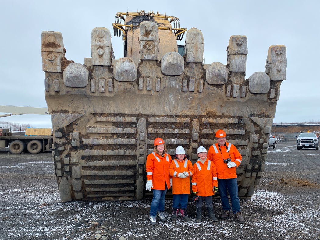 The Munson family of St. Louis Park stood in front of an excavator bucket at the Keetac taconite mine during a tour in April. The tour was prompted by their question about the state's largest machine.