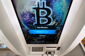 The Bitcoin logo appears on the display screen of a cryptocurrency ATM at the Smoker’s Choice store, Feb. 9, 2021, in Salem, N.H.