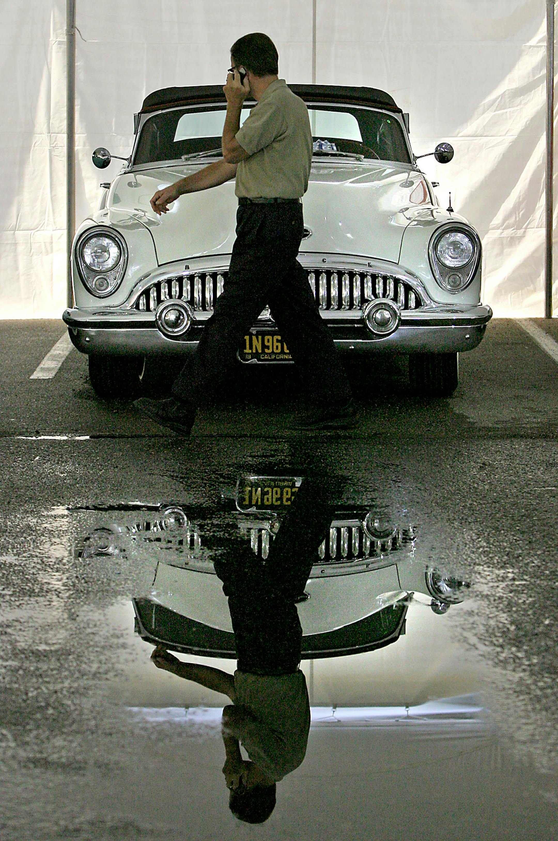 Jim Feely of Eagan made his way through a tent filled with cars during a preview of what is to be auctioned in the Rinstad Collector Car Auction that will include one of three remaining NASCAR Pace Car - 1969 Camaro, also a 1929 Duesenberg Model J Murphy Convertible Coupe worth an estimated $1 million. Cars are expected to bring over $10 million.