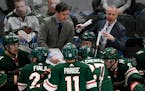Wild interim head coach Dean Evason, right, speaks to his players along with assistant coach Darby Hendrickson on March 1.