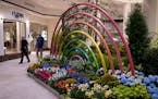 Mall walkers Debbie and Tom Welch, of Edina, walk past a planter installation. "This is incredible," said Debbie. "I can't imagine putting it all toge