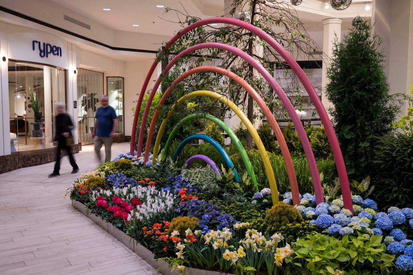 Mall walkers Debbie and Tom Welch, of Edina, walk past a planter installation. "This is incredible," said Debbie. "I can't imagine putting it all together."