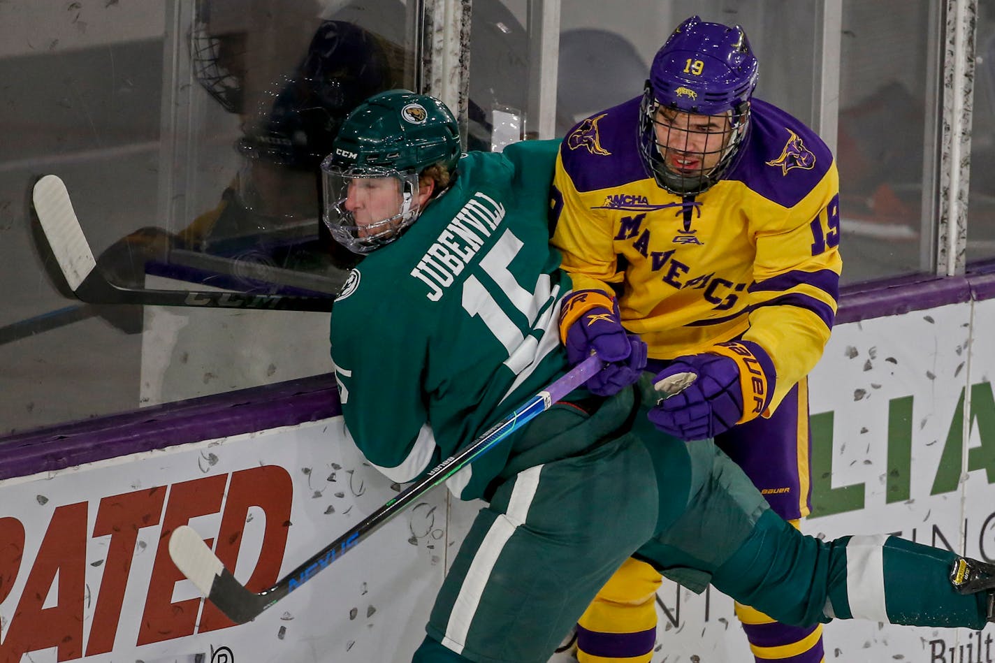 Bemidji State defenseman Tyler Jubenvill (15) competes with Minnesota State forward Chris Van Os-Shaw (19) during an NCAA hockey game on Friday, Dec. 18, 2020, in Mankato, Minn. (AP Photo/Bruce Kluckhohn)