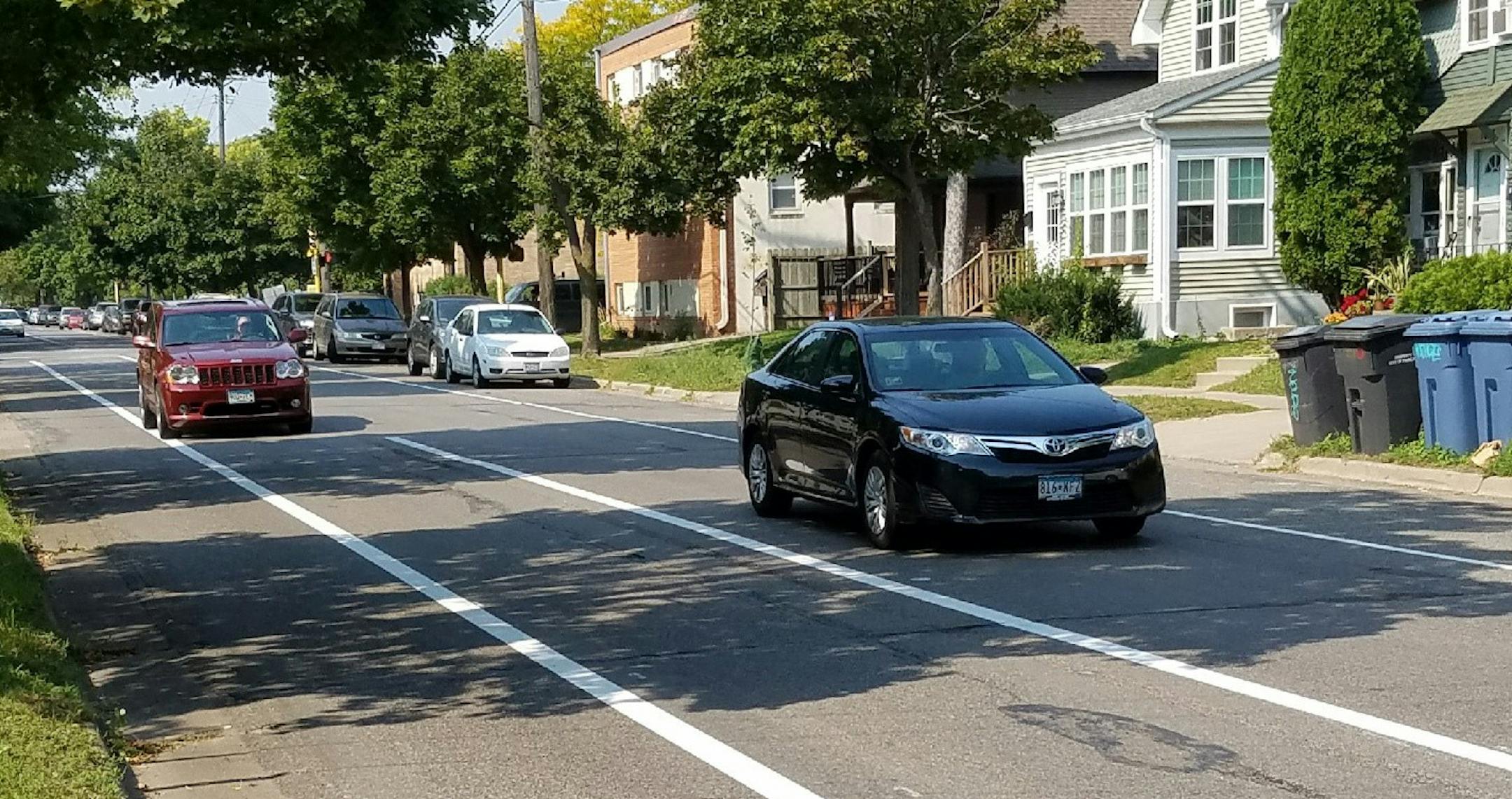 A Jeep is driven in the buffer zone on W. 28th Street at Colfax Ave. The 8-foot buffer zone is not a traffic lane. Photo by Tim Harlow. ORG XMIT: MIN1709141056100315