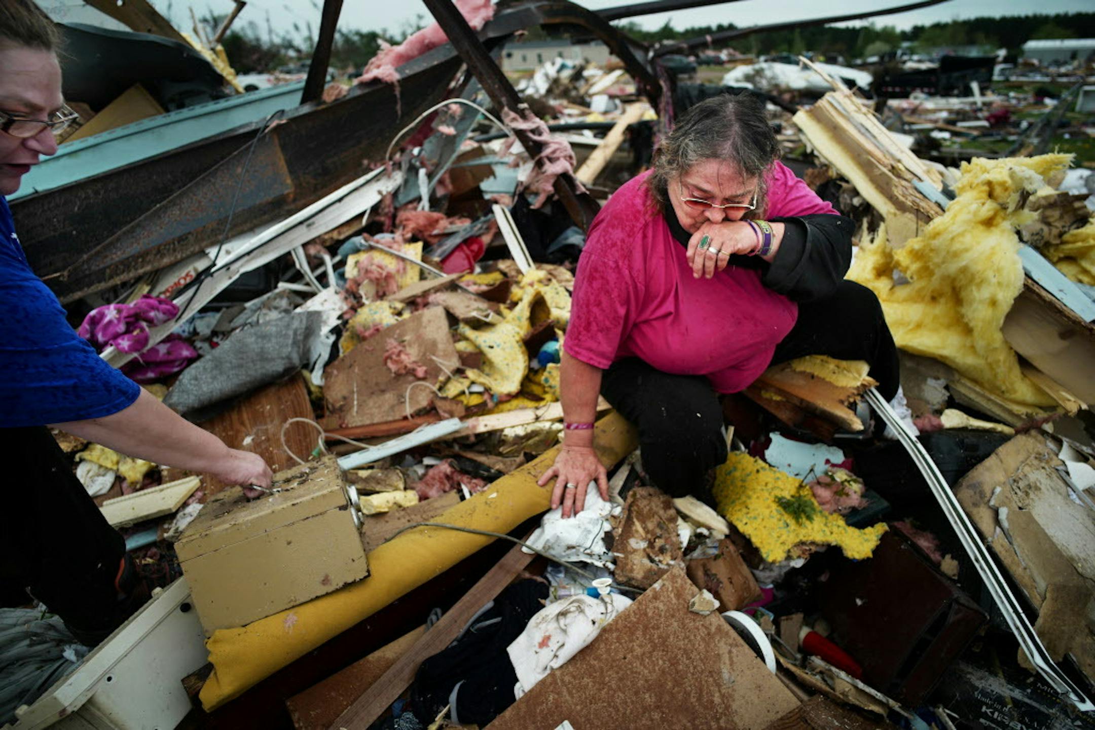 Cindy Rutledge, was crying out, "Colby, Colby" as she looked for her dachshund in the wreckage of her trailer home.On the left is daughter Deeann.