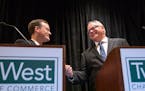 Candidates for governor Jeff Johnson and Tim Walz shook hands at the start of their debate at the Twin West Chamber of Commerce on Wednesday, Septembe