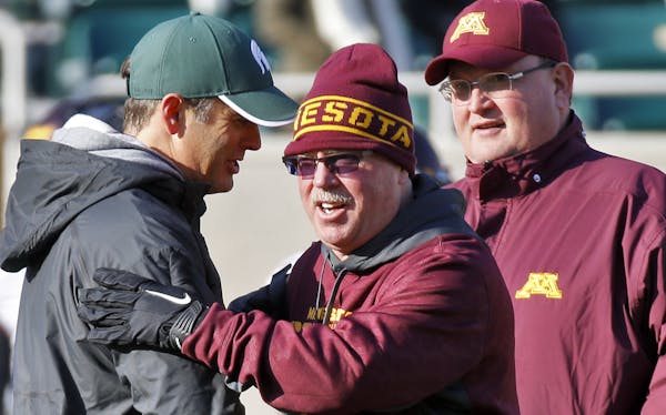 Minnesota Gophers vs. Michigan State Spartans. Minnesota head coach Jerry Kill, center, greeted a Michigan State coach before the start of the game as