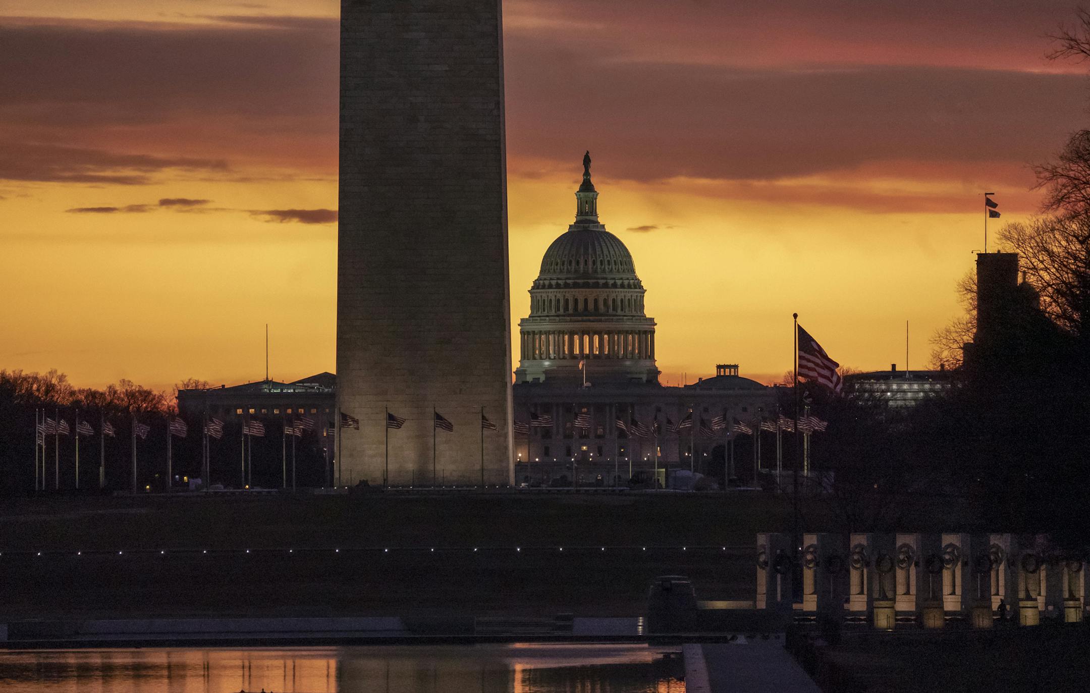 The Capitol and Washington Monument are seen at dawn as the partial government shutdown lurches into a third week with President Donald Trump standing firm in his border wall funding demands, in Washington, Monday, Jan. 7, 2019. After no weekend breakthrough to end a prolonged shutdown, newly empowered House Democrats are planning to step up pressure on Trump and Republican lawmakers to reopen the government. (AP Photo/J. Scott Applewhite)