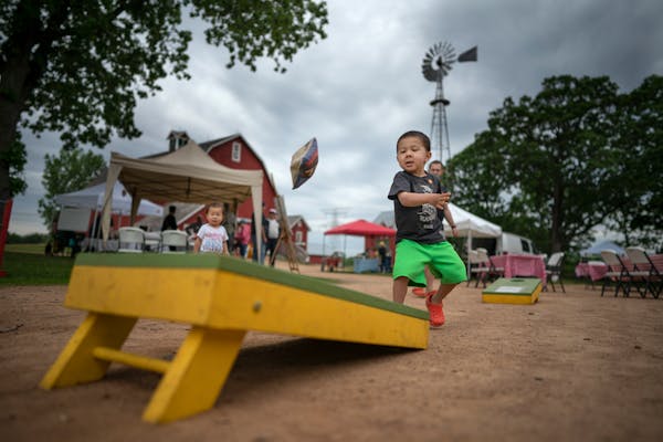 Henry Hurt, 3, tossed a beanbag while playing cornhole at Bruentrup Heritage Farm in Maplewood, Minn.