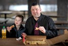 Scott Poepard and his son Kierson Popepard 8, ate pepperoni pizza from Savoy Pizza.] Jerry Holt •Jerry.Holt@startribune.com