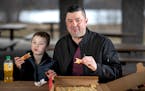 Scott Poepard and his son Kierson Popepard 8, ate pepperoni pizza from Savoy Pizza.] Jerry Holt •Jerry.Holt@startribune.com