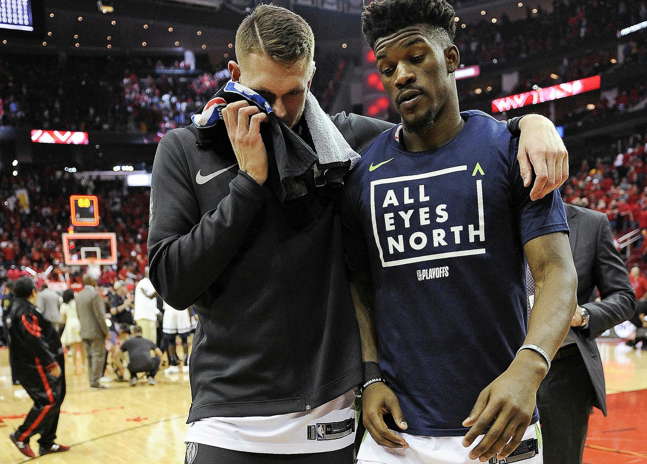 Minnesota Timberwolves' Jimmy Butler, right, and Cole Aldrich walk off the court after the team's 122-104 loss to the Houston Rockets in Game 5 of a first-round NBA basketball playoff series Wednesday, April 25, 2018, in Houston.