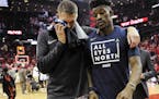 Minnesota Timberwolves' Jimmy Butler, right, and Cole Aldrich walk off the court after the team's 122-104 loss to the Houston Rockets in Game 5 of a f