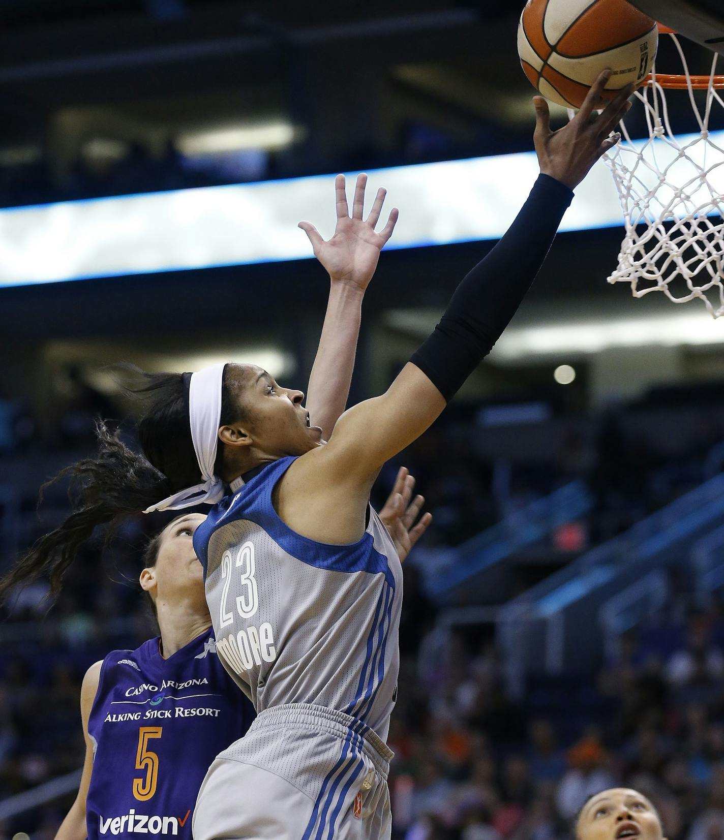 Minnesota Lynx's Maya Moore (23) drives past Phoenix Mercury's Sonja Petrovic (5) to score as Mercury's Mistie Bass, right, watches during the first half of a WNBA basketball game Wednesday, May 25, 2016, in Phoenix. The Lynx defeated the Mercury 85-78. (AP Photo/Ross D. Franklin)