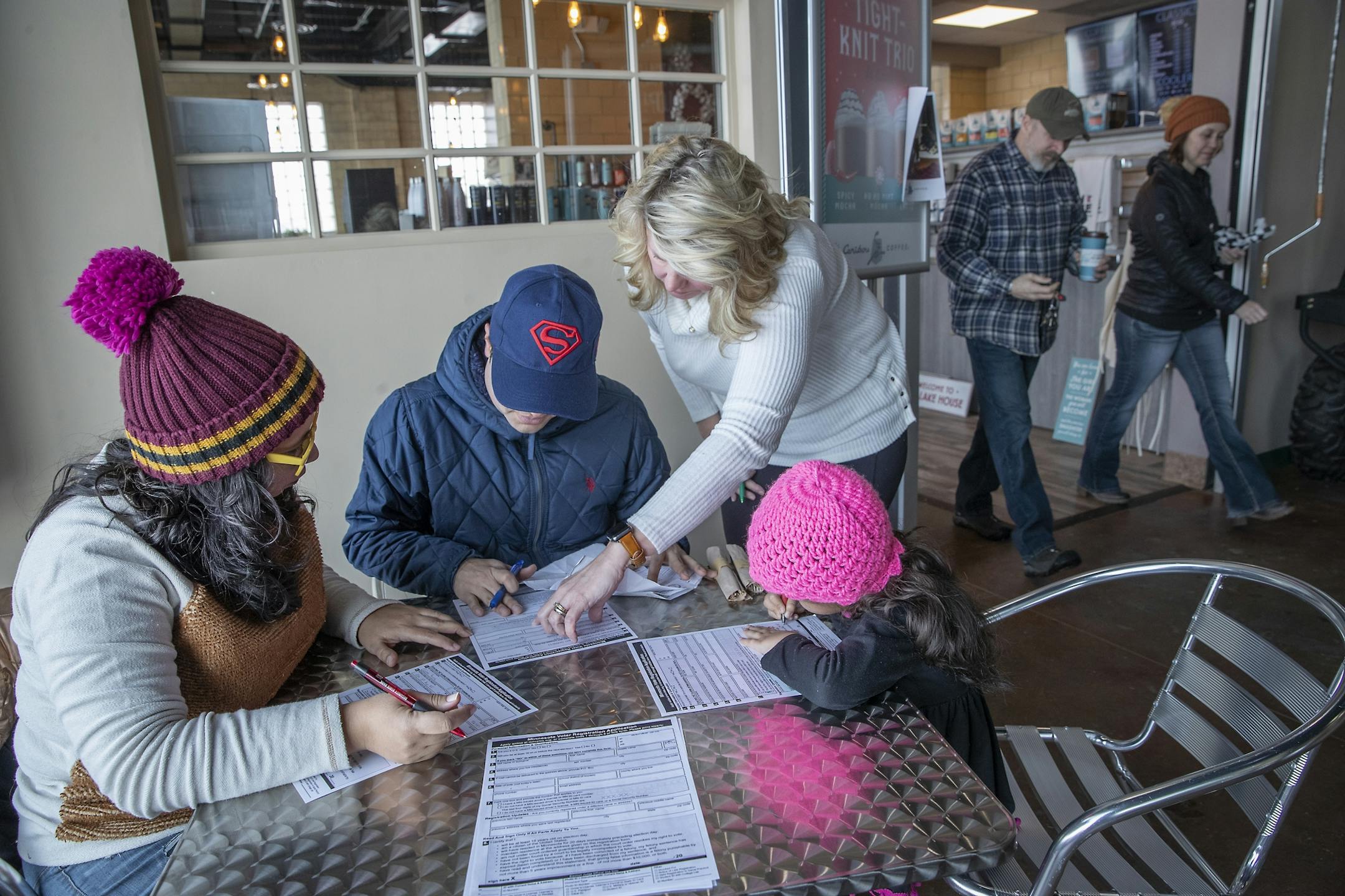 Karen Lopez Rivera, and her husband Edwin Colon Perez and their daughter Irianis Colon Lopez, 5, worked on filling out voter registration forms with there help of their ESL teacher Traci Pederson, at a local coffee shop, Monday, February 17, 2020 in Roseau, MN.