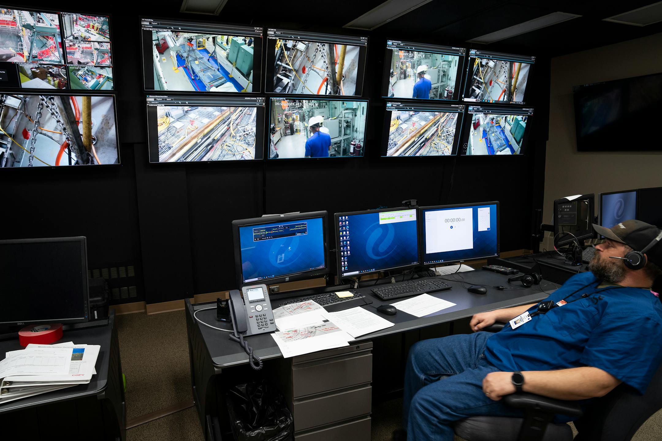 Radiation protection specialist Joseph Frechette watches the monitors inside the radiation protection viewing room.