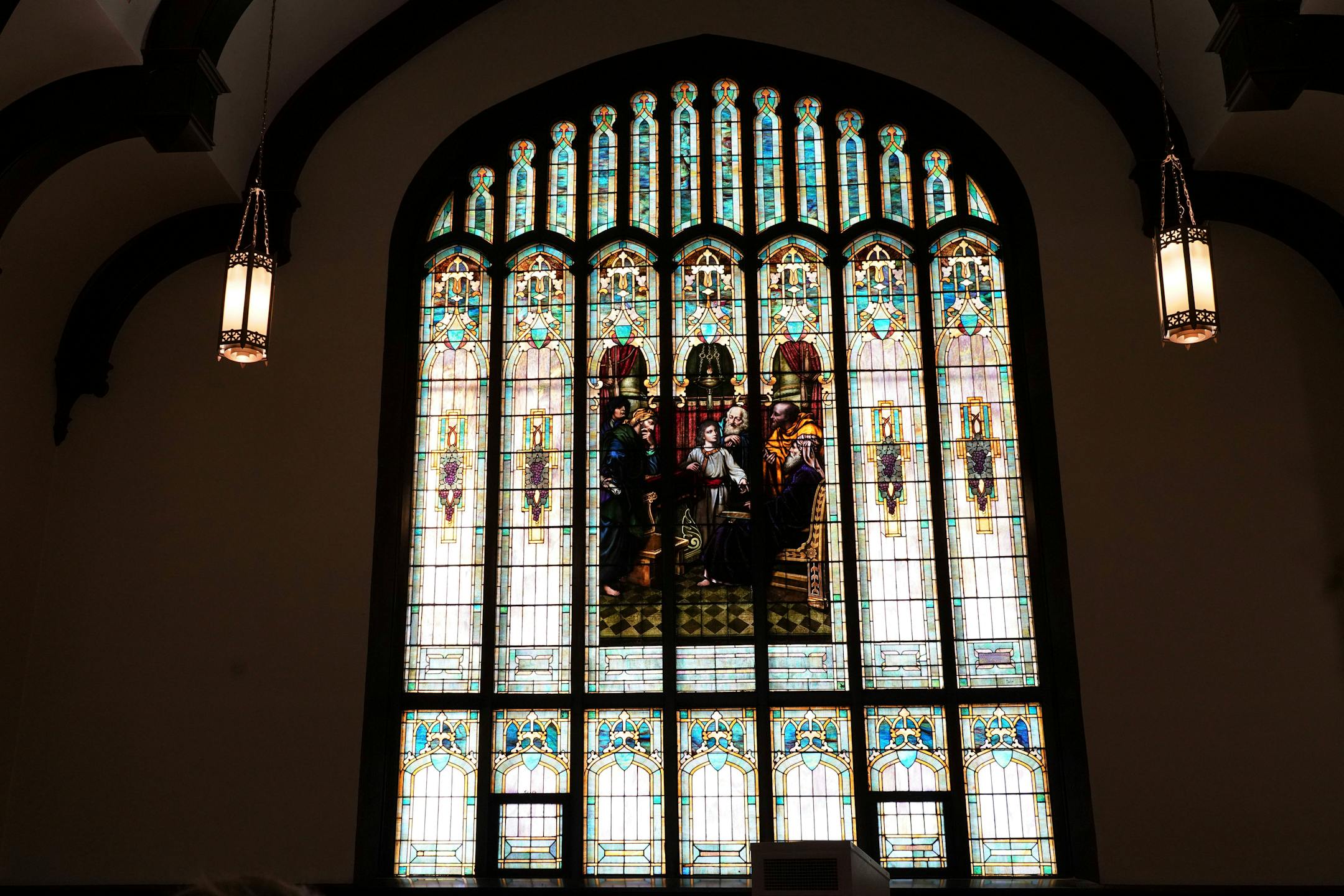 A colorful stained-glass window adorns Holy Trinity Lutheran Church, Sunday, Jan. 23, 2022, in Minneapolis. With attendance dwindling, historic urban churches built in the early to mid-20th century, are fulfilling their faith-based mission to serve their neighbors. (AP Photo/Jim Mone)