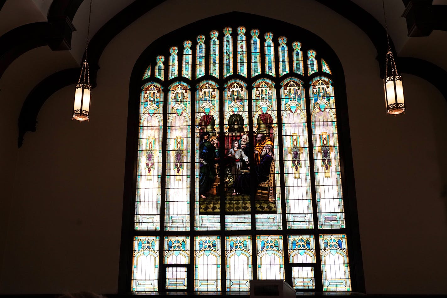 A colorful stained-glass window adorns Holy Trinity Lutheran Church, Sunday, Jan. 23, 2022, in Minneapolis. With attendance dwindling, historic urban churches built in the early to mid-20th century, are fulfilling their faith-based mission to serve their neighbors. (AP Photo/Jim Mone)