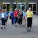 The Great Lakes Nordic Walkers Open House held at Centennial Lakes in Edina ended with a group walk. (Left to right) Walking in front, wearing matchin