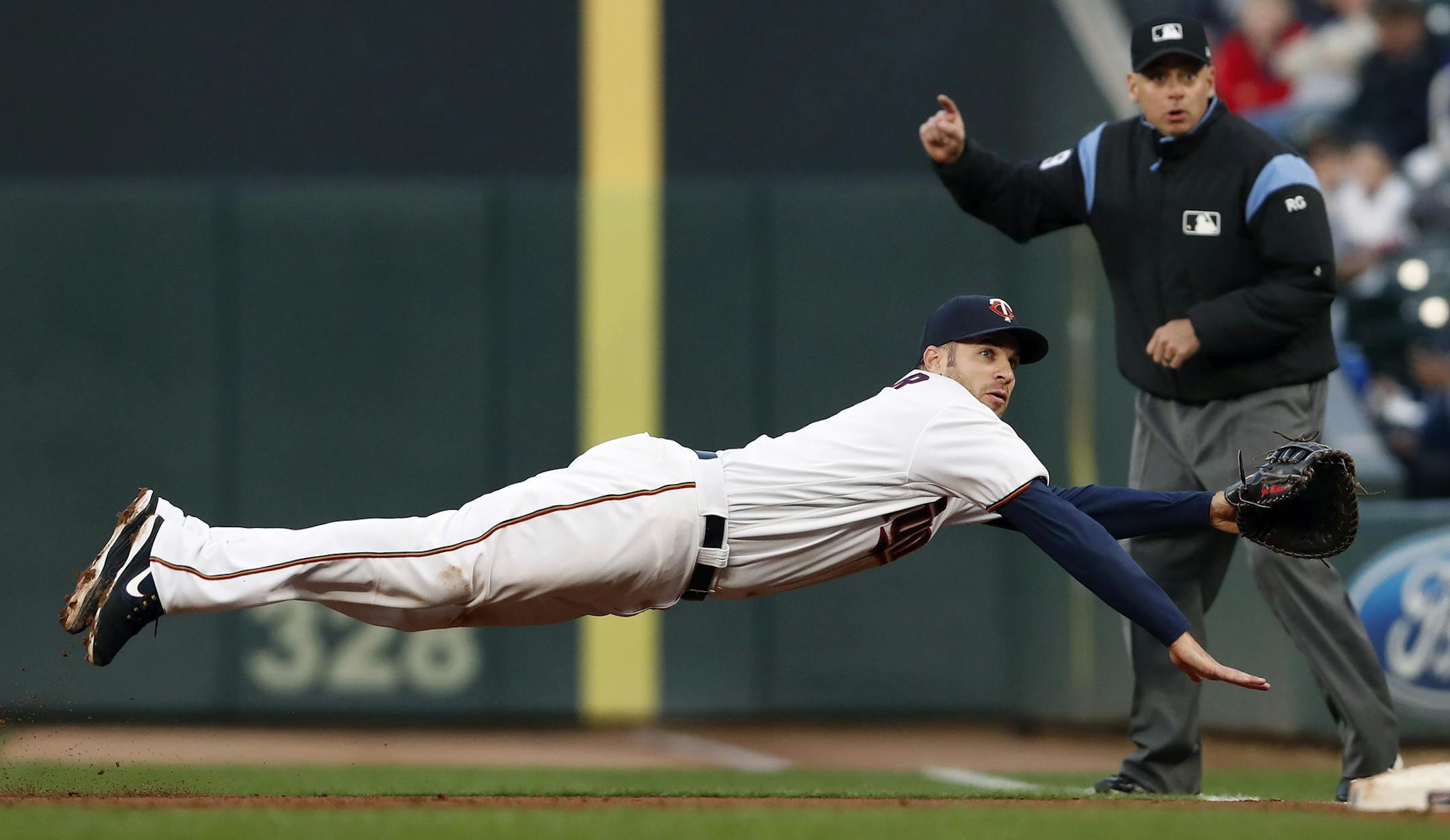 Twins first baseman Joe Mauer extended himself to snag a grounder down the line in the second inning Monday night, but the Indians' Jose Ramirez was safe at first.