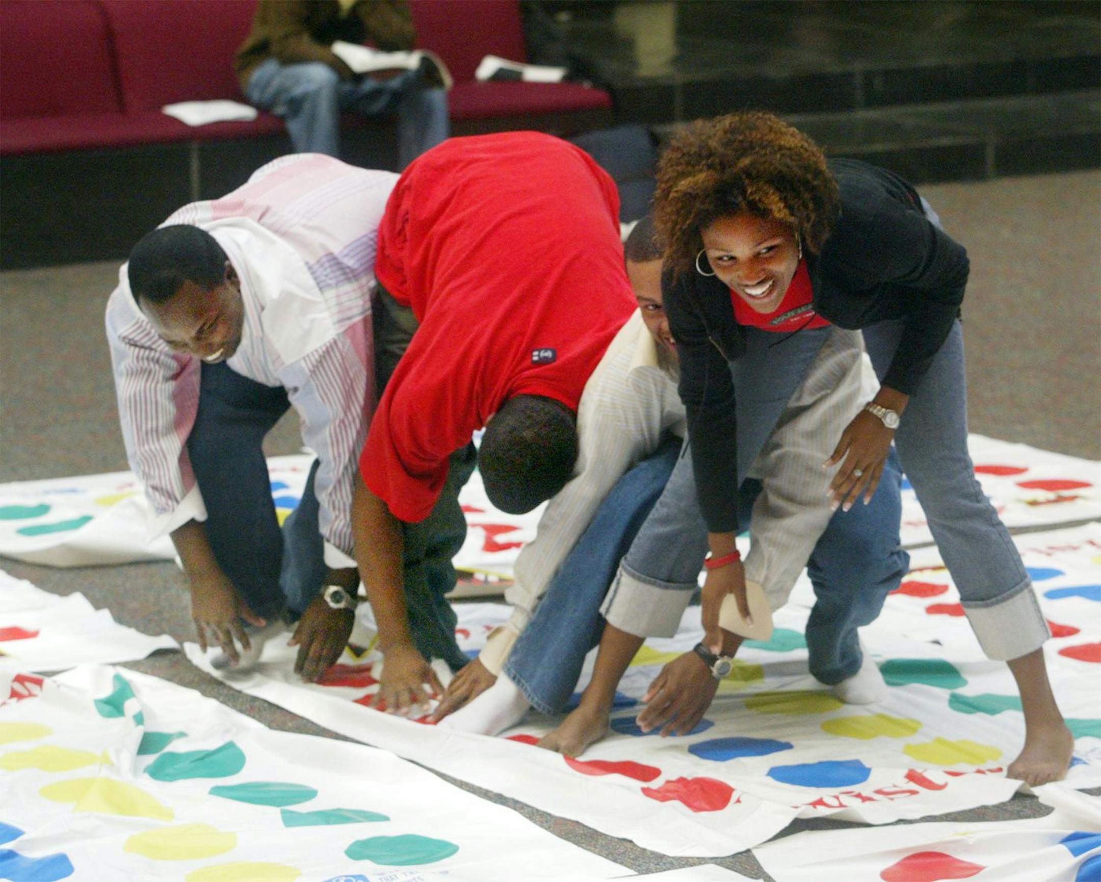 In this file photo, people play Twister in Edwardsville, Ill. Charles "Chuck" Foley, inventor of the iconic Twister game, died Monday, July 1, 2013, at a care facility in St. Louis Park, Minn, according to his son, Mark Foley. He was 82.