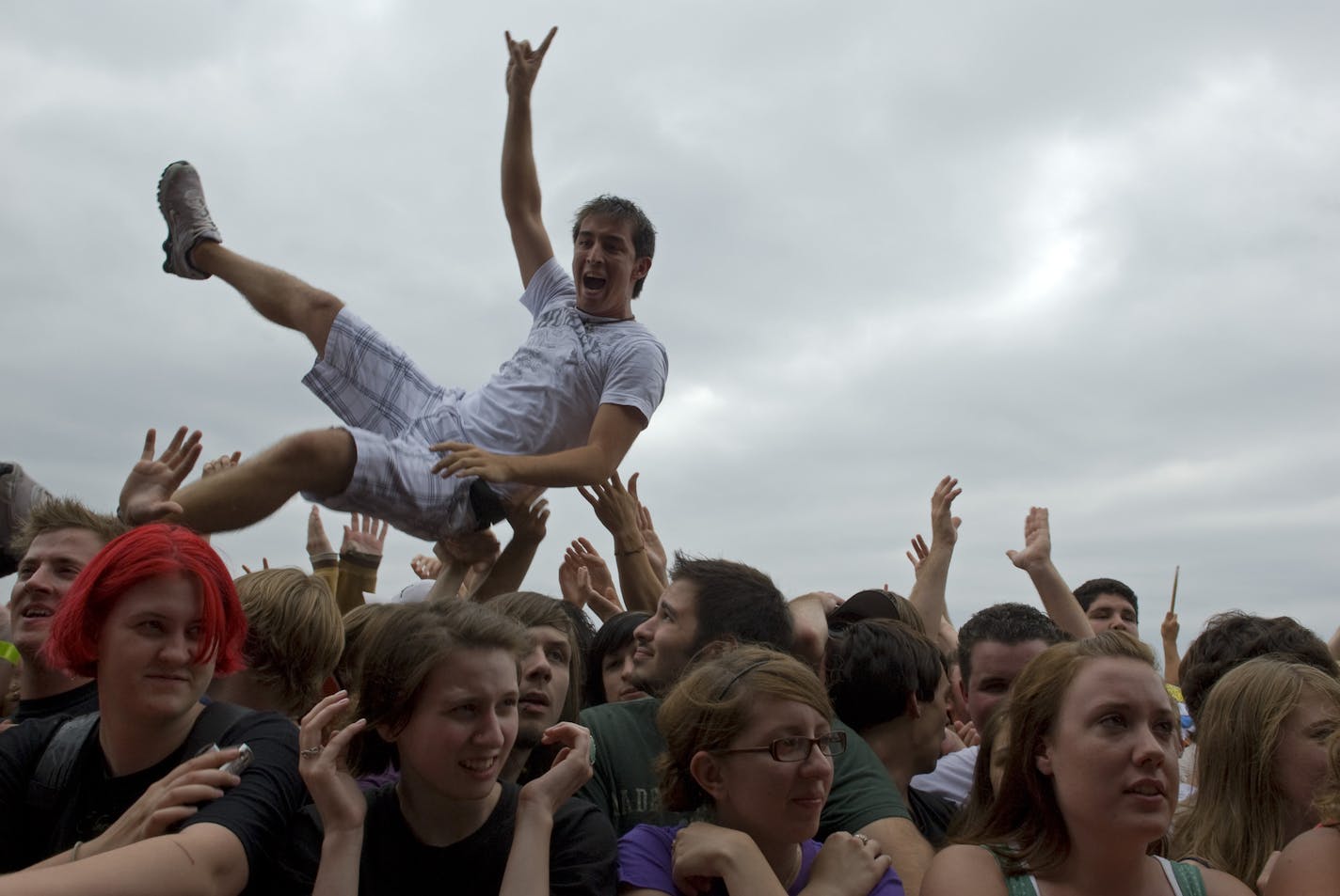 m.k. smith - mksmith@startribune.com Shakopee, Minn. 08032008 ] In its 14th year, the Warped Tour is a mainstay of the summer concert season, offering its mix of hyper punk-rock and X-game-sports for teens. A crowd surfer makes is way from the back of the crowd about 40 rows deep to the front row where security pulled him down and helped him back into the crowd, during a performance by band Anberlin. ORG XMIT: MIN2013071213111530