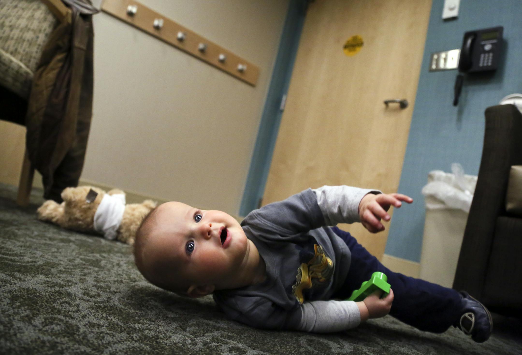 Dr. Suzanne Pauly with her son Michael, eight months, Tuesday, May 6, 2014, at Gillette Children's Specialty Healthcare in St. Paul, MN. Michael was born with synostosis, a birth defect in which the bones of the skull fuse too soon, and had surgery in December to reshape the bones of his skull. Michael is now doing well.](DAVID JOLES/STARTRIBUNE) djoles@startribune Dr. Suzanne and Jason Pauly are the parents. Michael is the baby. Michael was born 8/27/13 with synostosis, a birth defect in which