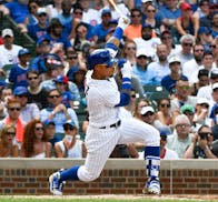 Chicago Cubs' Javier Baez (9) hits a two-RBI double during the second inning of a baseball game against the Minnesota Twins on Sunday, July 1, 2018, i