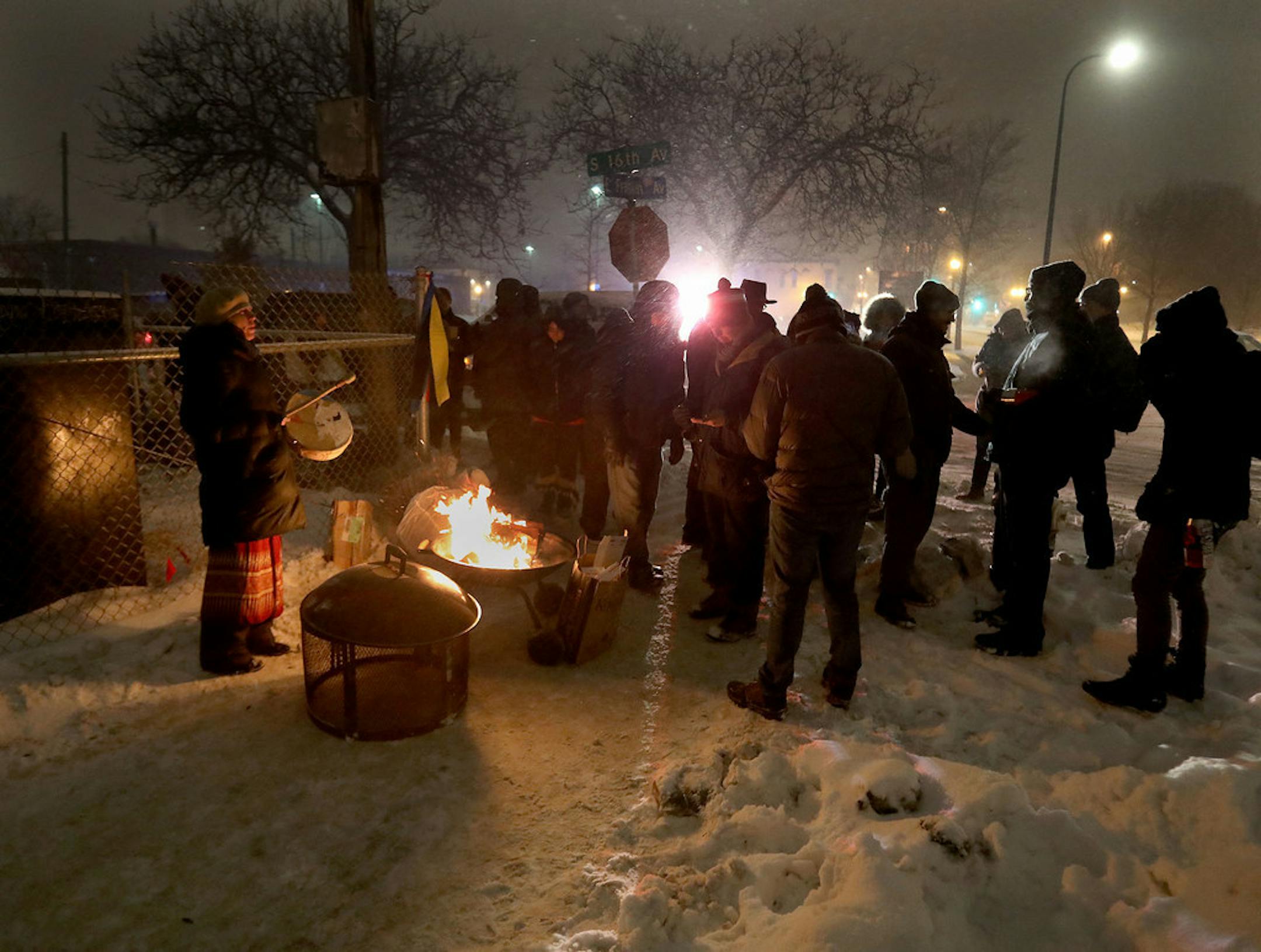Native American community members and leaders gathered around a fire before a teepee was erected during the early morning hours on Saturday along Franklin and Hiawatha avenues, at the site of the former homeless encampment known as the "Wall of the Forgotten Nativss."