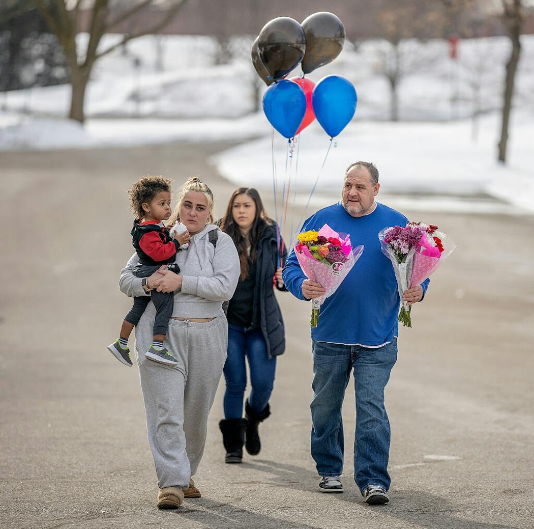 “We come here out of respect,” said Dell Williams as he and his daughter Abbey Williams, and her son Xavier, 2 and Joanna Mendoza, back, visit three memorials in front of the Burnsville Police Department.