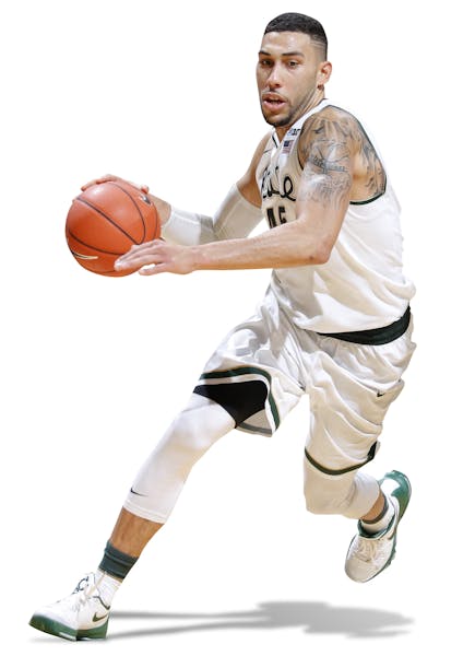 Michigan State's Denzel Valentine drives to the basket during the second half of an NCAA college basketball game against Louisville, Wednesday, Dec. 2