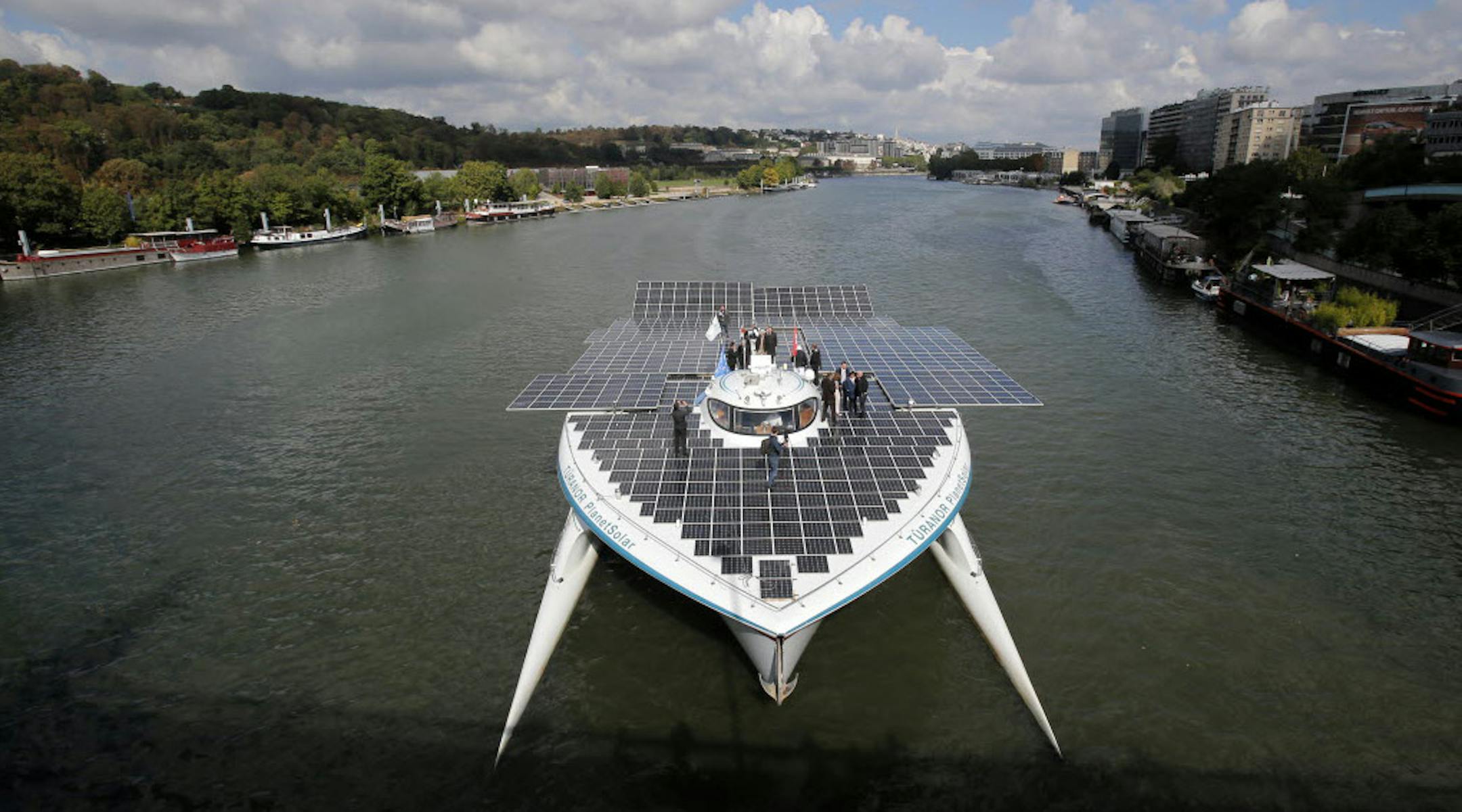 The Turanor PlanetSolar, the world’s largest solar boat, traveled on the Seine River outside Paris on Tuesday to complete its three-month Atlantic voyage.