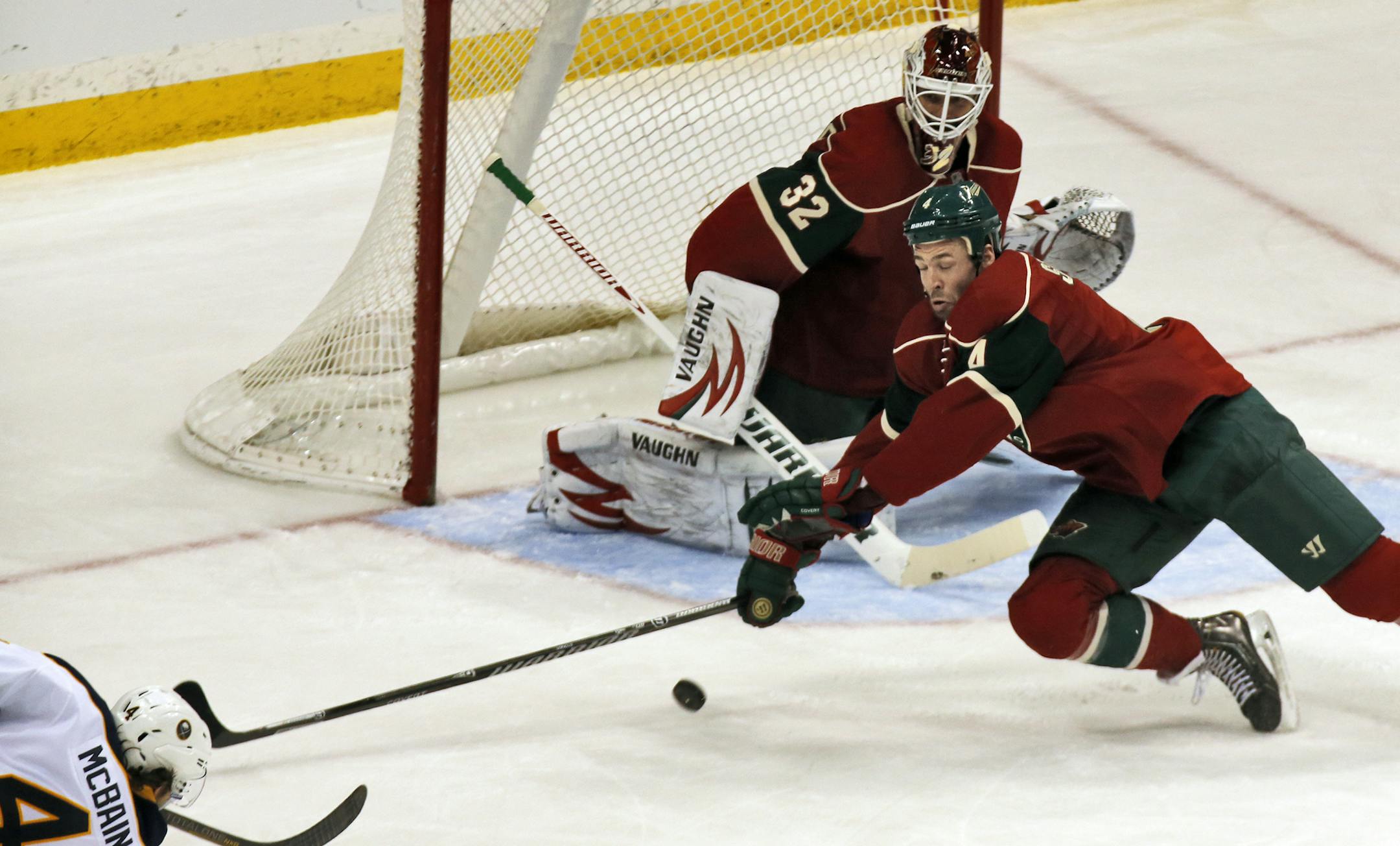 Minnesota Wild vs. Buffalo Sabres. Minnesota scored three goals in the 2nd period. Wild Clayton Stoner helped goalie Niklas Backstrom defend against a shot on goal by Sabres Jamie McBain. (MARLIN LEVISON/STARTRIBUNE(mlevison@startribune.com)