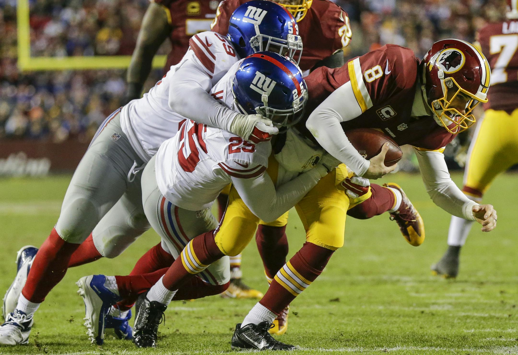 New York Giants outside linebacker Devon Kennard (59) and defensive back Leon Hall (25) sack Washington Redskins quarterback Kirk Cousins (8) during the second half of an NFL football game in Landover, Md., Sunday, Jan. 1, 2017. (AP Photo/Mark Tenally)