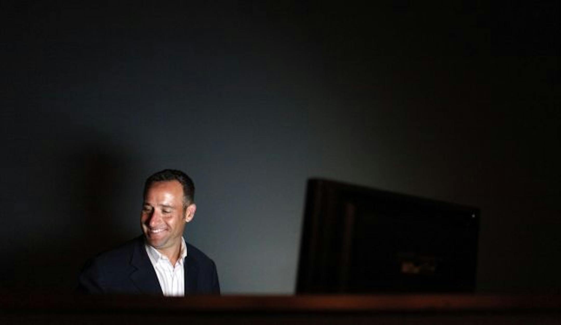 Rick Bronson, owner of the House of Comedy, works the lights and sound board during the club's opening night in the Mall of America.