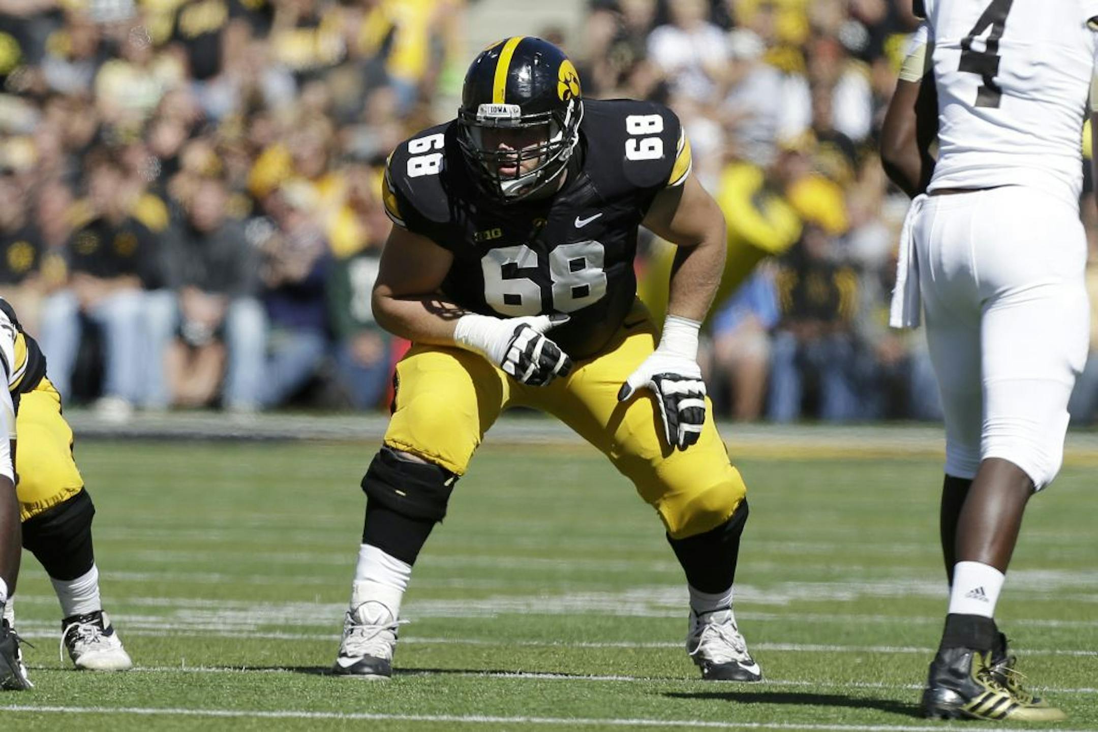 Iowa offensive linesman Brandon Scherff gets set on the line of scrimmage during the first half of an NCAA college football game against Western Michigan, Saturday, Sept. 21, 2013, in Iowa City, Iowa.