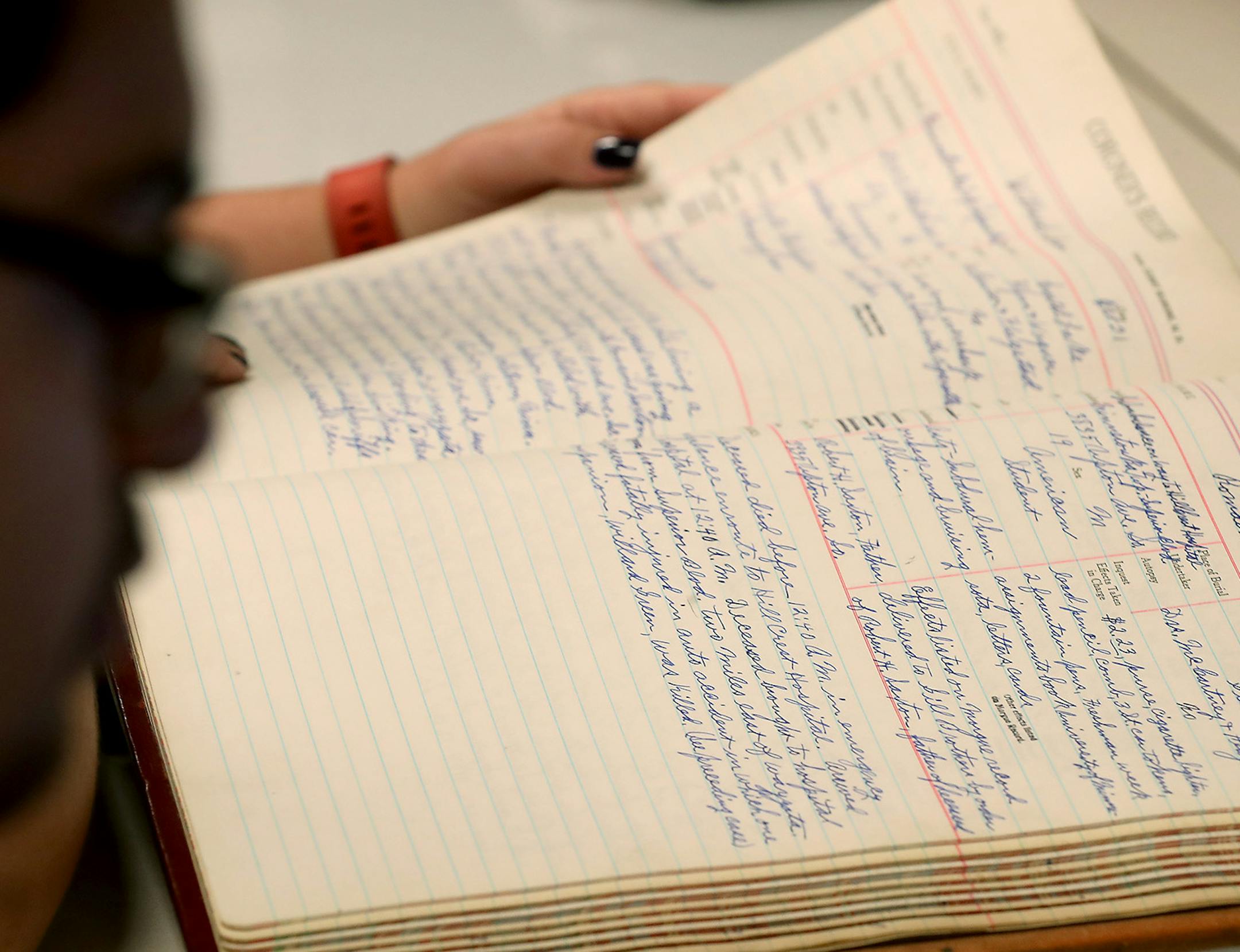 Leo Loza, left, a U of M student, and Hailey Johnson, a U of M graduate, worked on documenting information from a 1931 coroner report at the Hennepin County Medical Examiner's Office, Wednesday, July 27, 2016 in Minneapolis, MN. Researchers, who are all students, are getting a rare look into documents from the past 110 years, indexing the deaths for the Medical Examiner's Office and tracking homicide trends. ] (ELIZABETH FLORES/STAR TRIBUNE) ELIZABETH FLORES • eflores@startribune.com