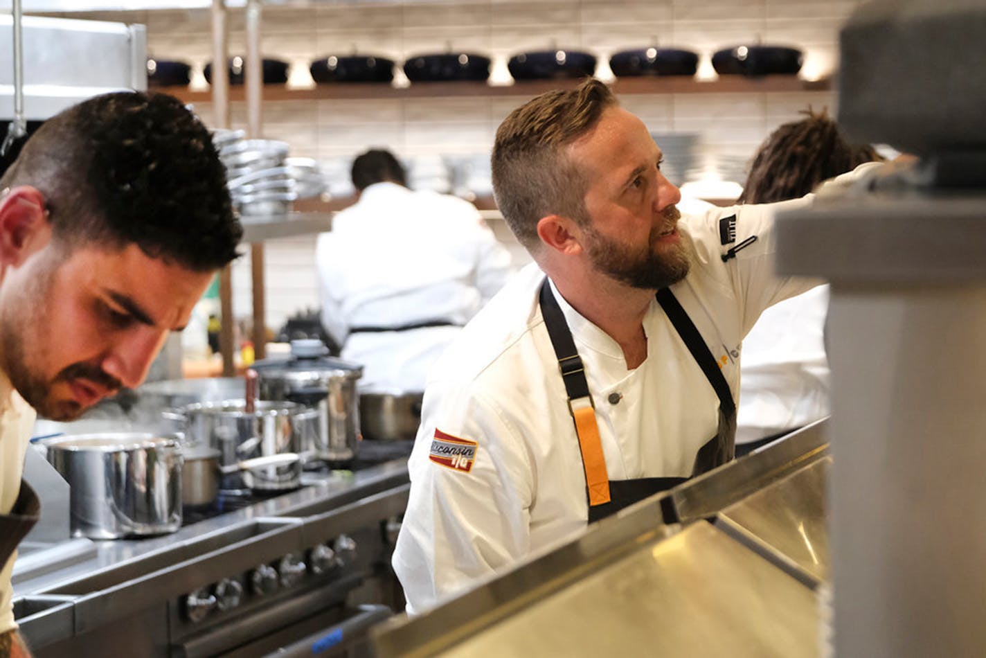 Two chefs, Manuel "Manny" Barella Lopez and Daniel Jacobs, working together in a kitchen on "Top Chef."