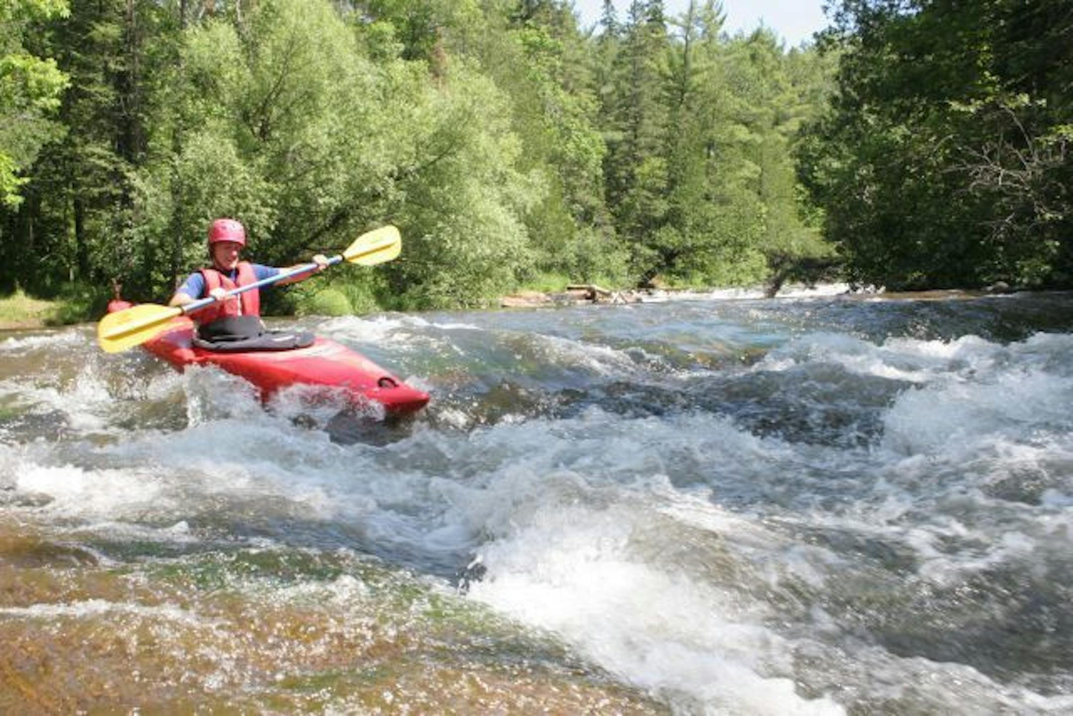 A kayaker works his way through the Mays Ledges section of the Brule River in Wisconson.