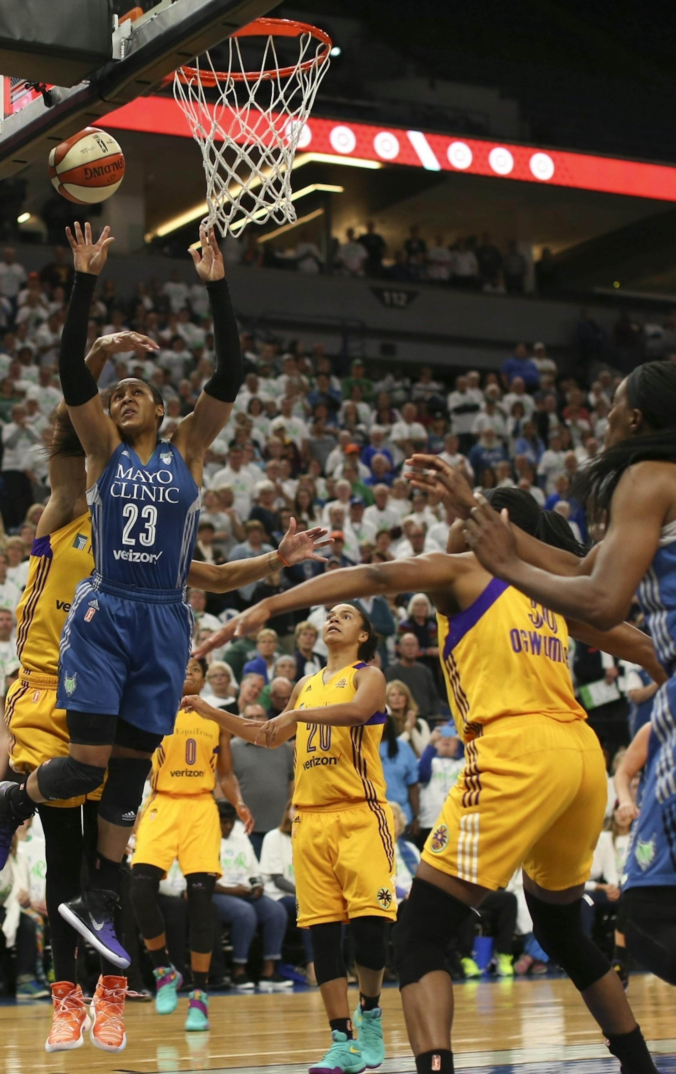 Minnesota Lynx forward Maya Moore (23) was fouled by Los Angeles Sparks forward Candace Parker (3) as she shot in the second half.