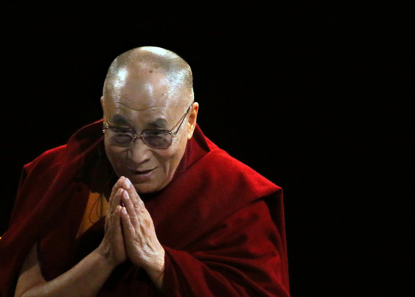 His Holiness the 14th Dalai Lama greeted the crowd at the Nobel Peace Prize Forum in March 2014 as he prepared to give the keynote.