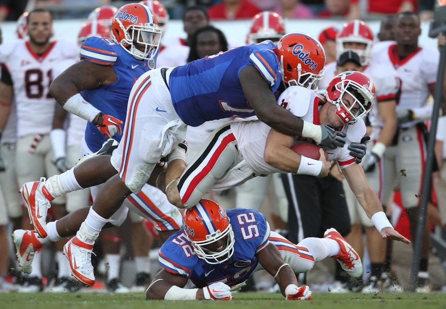 Florida defensive tackle Sharrif Floyd (73) tackles Georgia quarterback Aaron Murray (11) in 2011