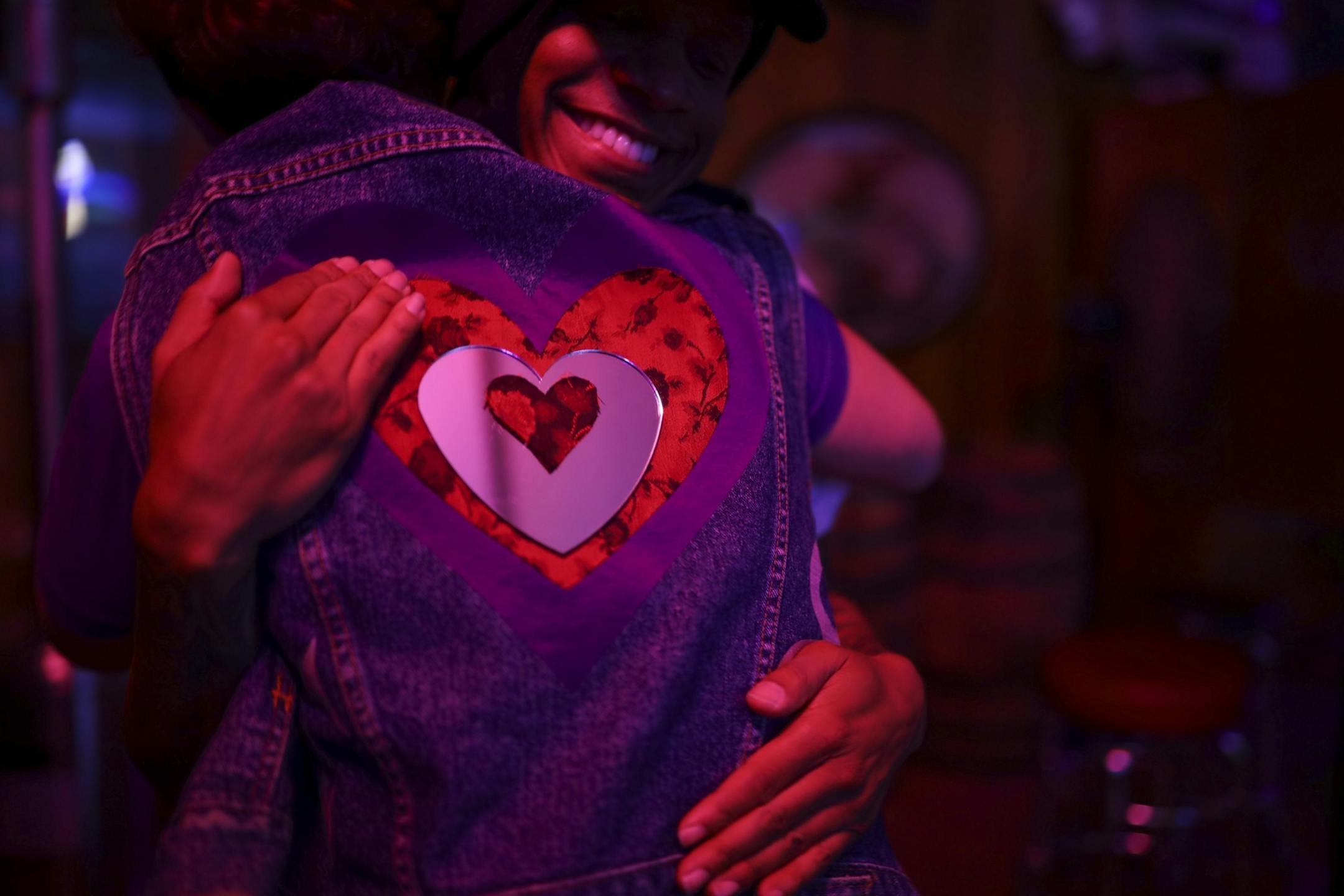Willie Adams of Oakland, CA hugged Heidi Vader after presenting her with a jean jacket vest he'd made for her Wednesday night at the "Free Urself Dance Party." Adams is a board member of Purple Playground and was also DJ'ing at the event.