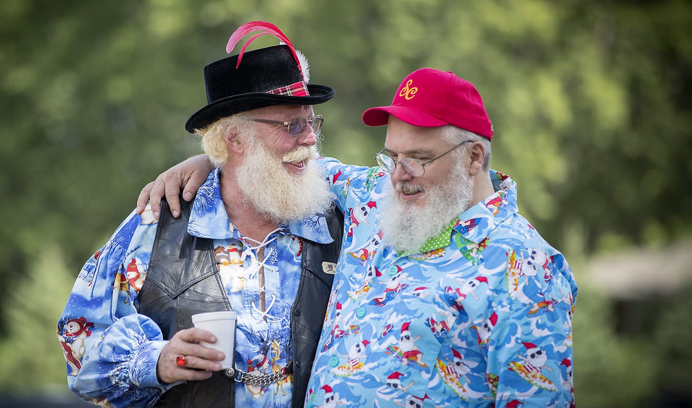 Santa Rob Mathewson, left, and Santa Bruce Olson greeted each other with a hug a they joined other &#x201c;Minnesota Santas&#x201d; for a summer picnic at the Bruentrup Heritage Farm in Maplewood.